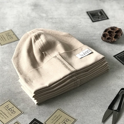 Vaikiška vienguba kepurė TRENDY kreminės spalvos